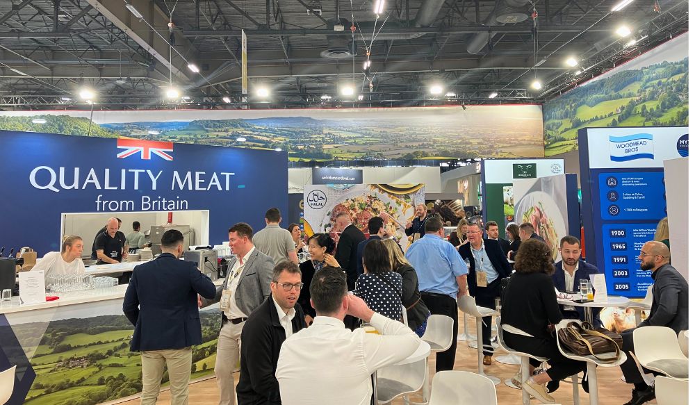 People mingling on a trade exhibition stand in a large hall